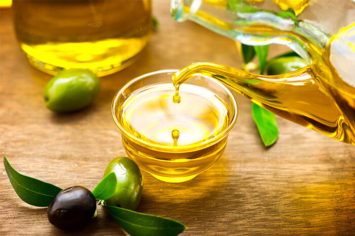 olive oil pored into a grass