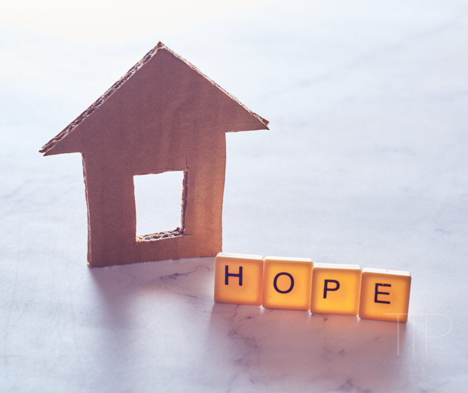 cut out house from cardboard and words hope