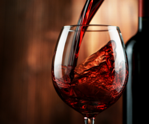 red wine pouring into a wine glass