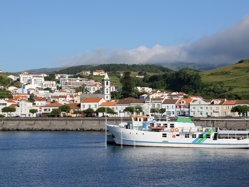 a boat passing a village in Acores