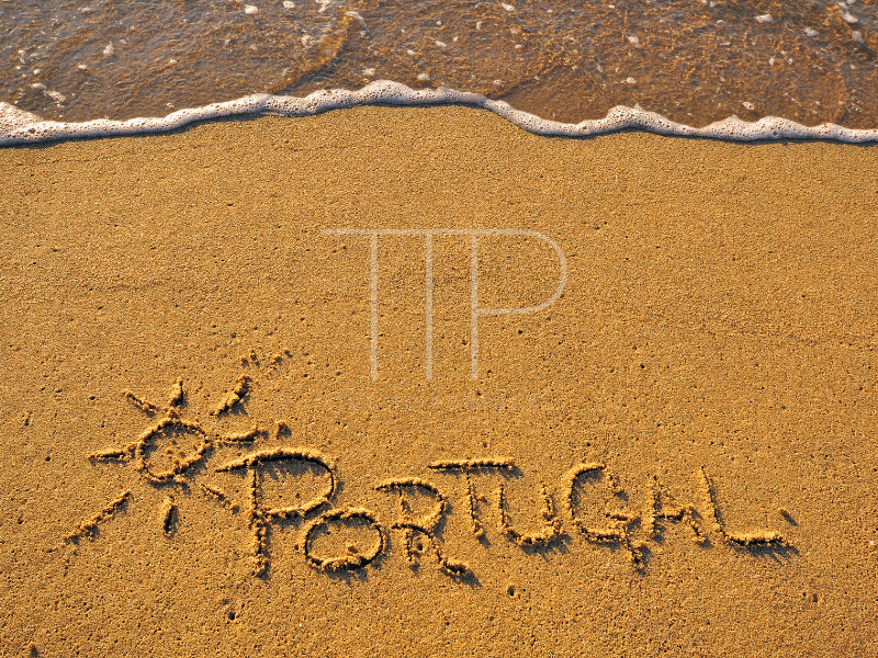 Word Portugal written in beach sand