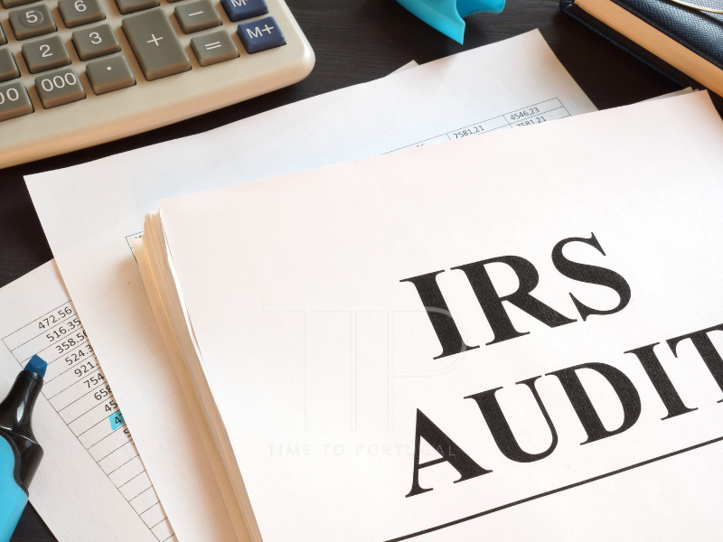 IRS AUDIT printed big on white paper and a calculator