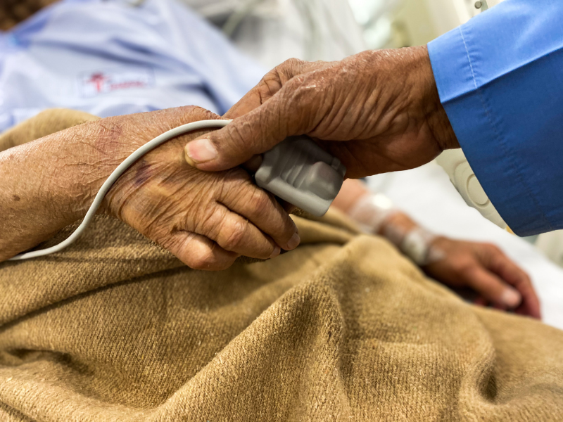 couple holding hands at hospital bed