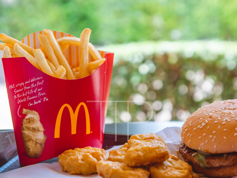 Chicken nuggets, fries and burger on a table