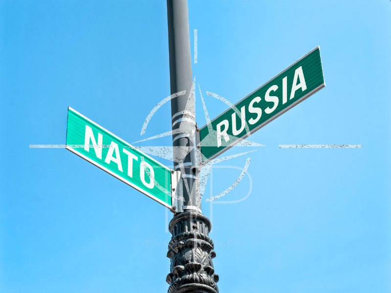 Two green street signs with words NATO and RUSSIA