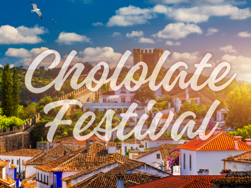 Medieval town with stone walls in background, words chocolate festival in focus
