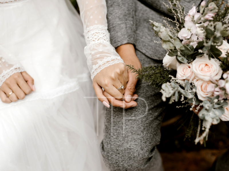 White brides dress and groom holding hands