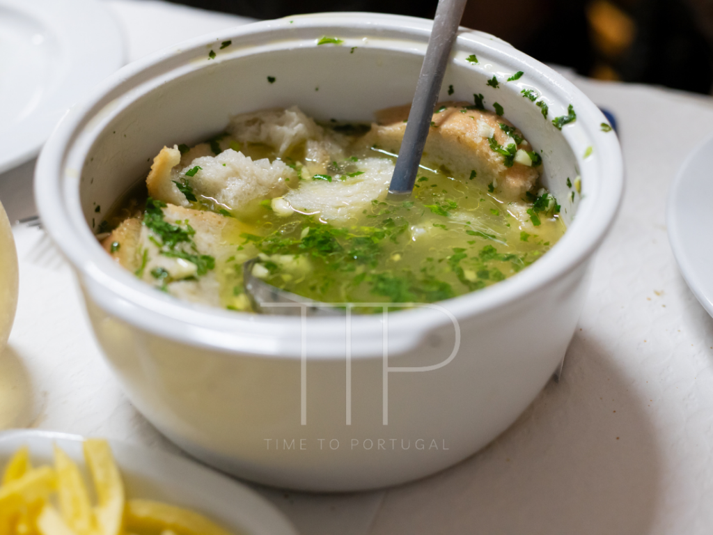 a white soup bowl with bread soup