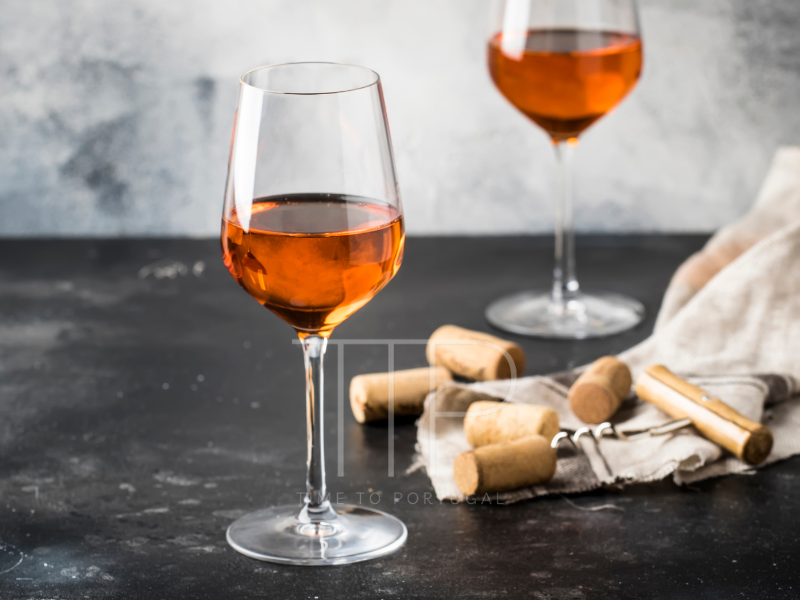 Two glasses of orange wine on dark table