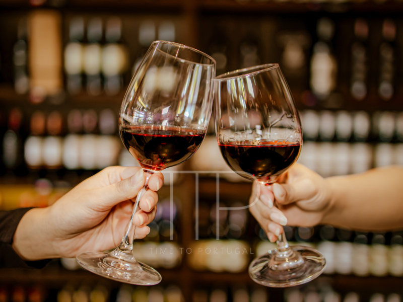 Two hands holding a glass of red wine each